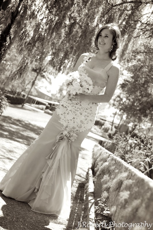 Sepia of bride with mossy bridge - wedding photography sydney